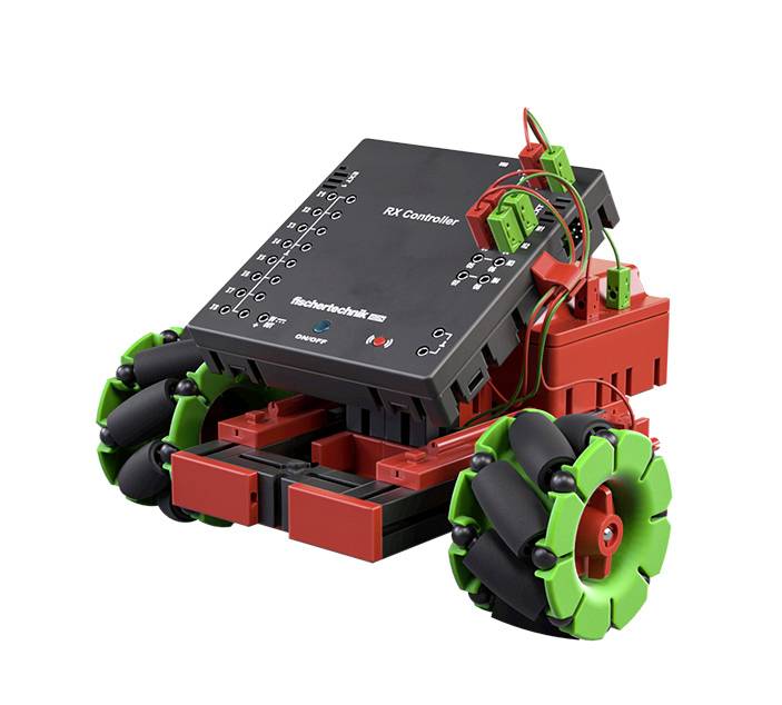 Hračkový robot se zelenými koly a červenou skříní. Elektronický modul nahoře; umožňuje různé pohyby.