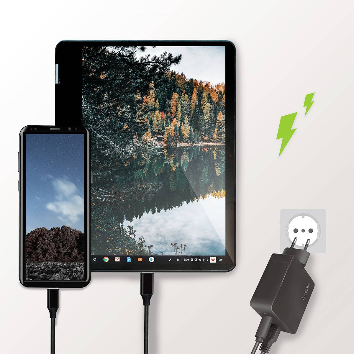 Smartphone a tablet připojené k nabíjecí stanici, zapojené do elektrické zásuvky. Symbol blesku ukazuje probíhající nabíjení.