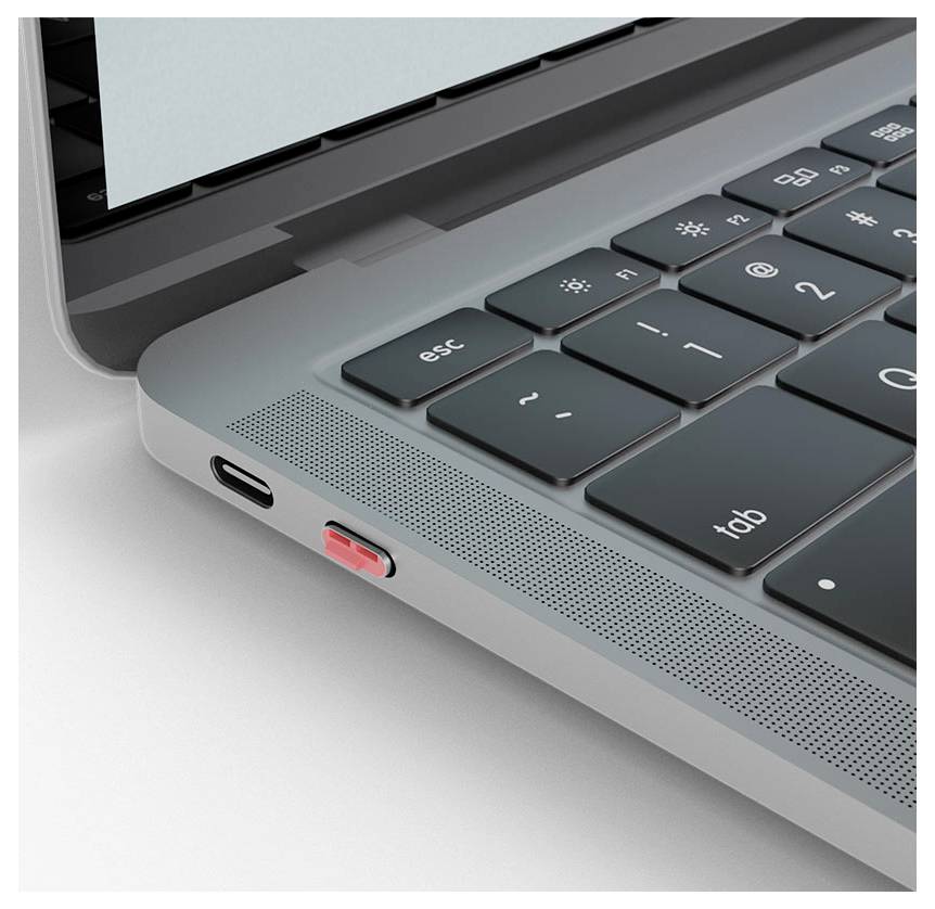 Detailní záběr na roh notebooku ukazující klávesnici, port USB-C a červený USB flash disk zapojený do strany.