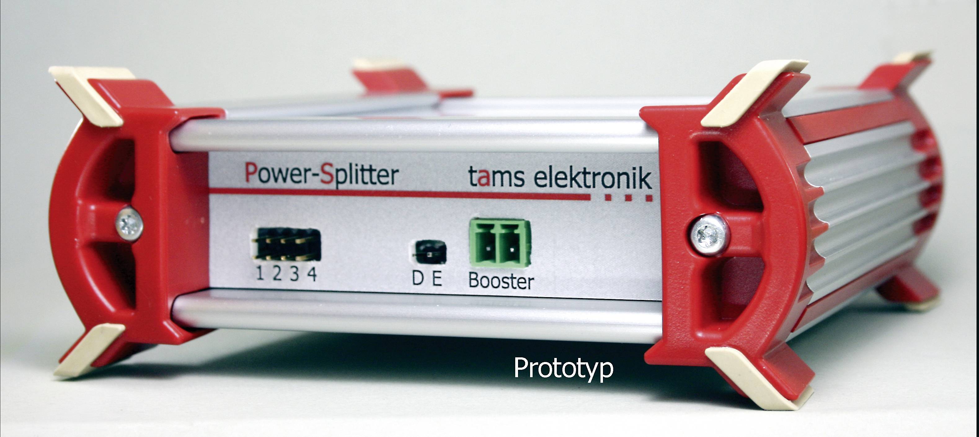 Červeno-bílé elektronické zařízení s nápisem 'Power-Splitter tams elektronik', s přepínačem a zdířkami na přední straně.