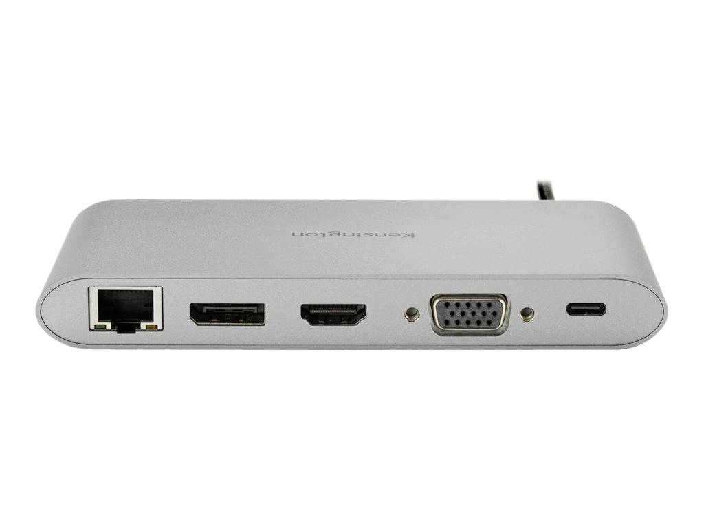 Stříbrné adaptérové zařízení s přípoji: LAN, 2x HDMI, VGA a USB-C. Vhodné pro připojení laptopů nebo počítačů.
