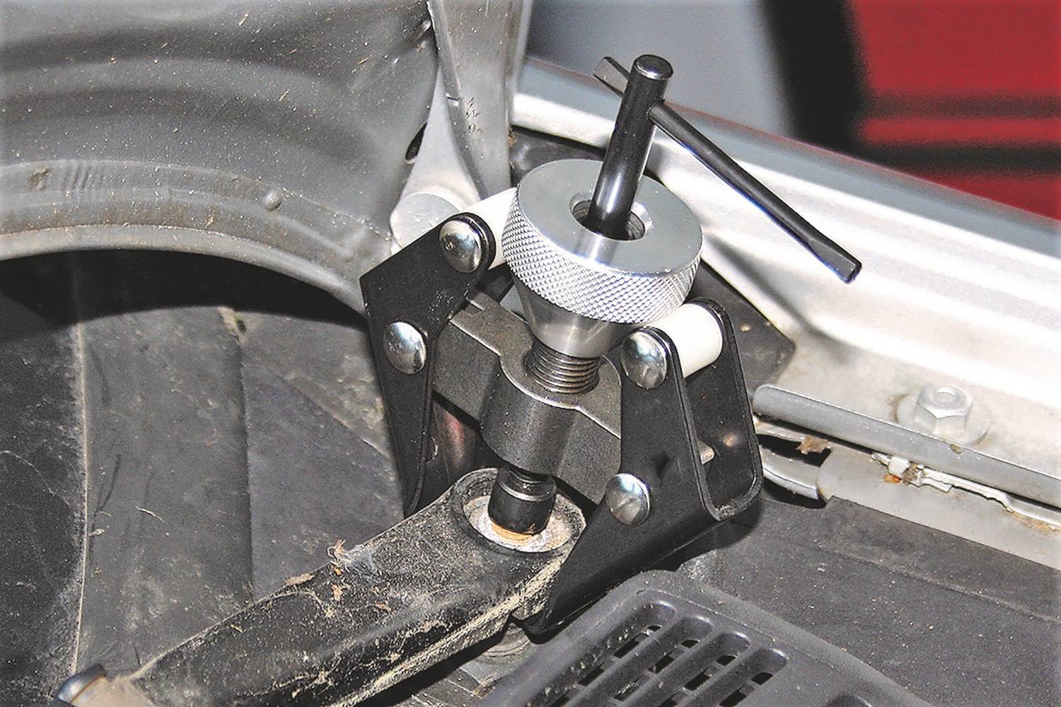 Stahovák kulového kloubu je upevněn na části vozidla. Tento nástroj slouží k demontáži kulových kloubů při opravách automobilu.