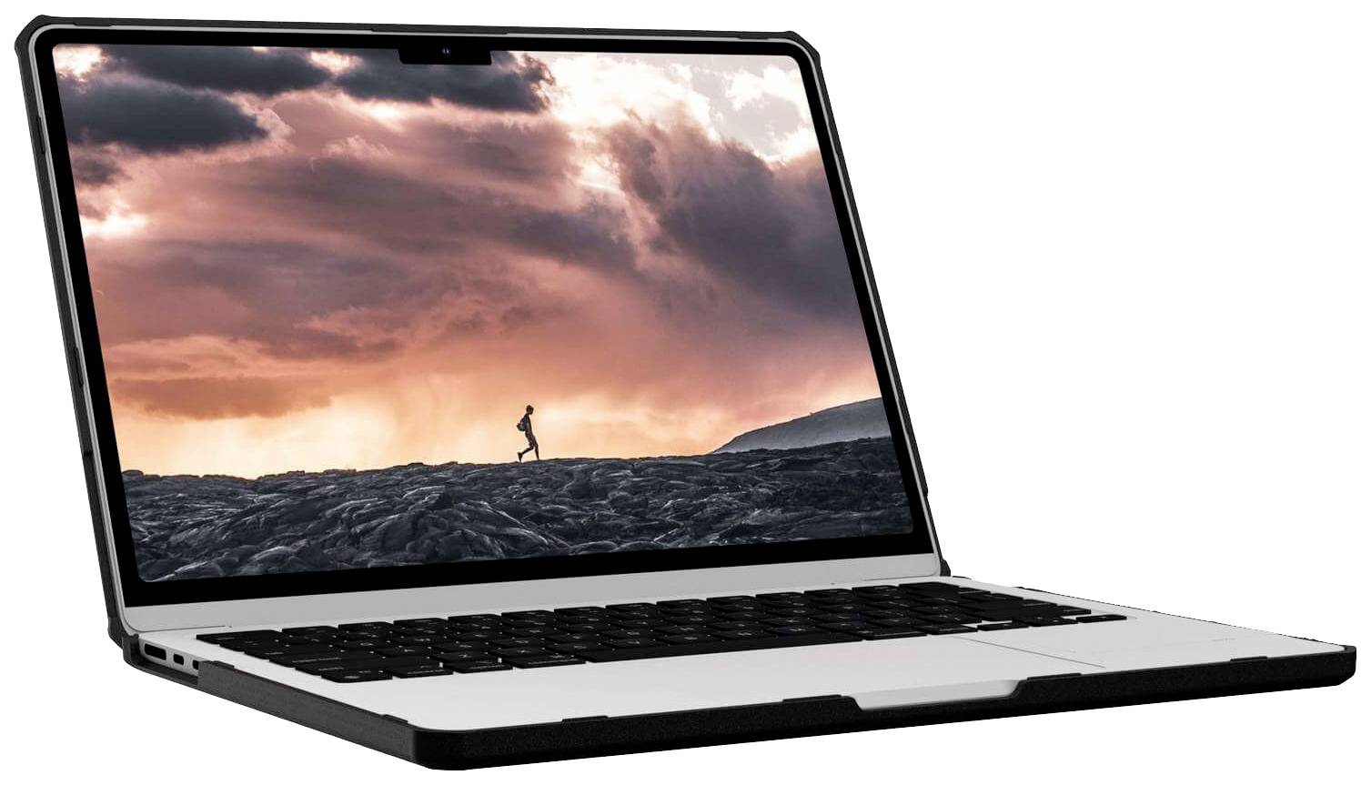 Notebook s spořičem obrazovky zobrazujícím osobu běžící po vulkanické hornině za soumraku.