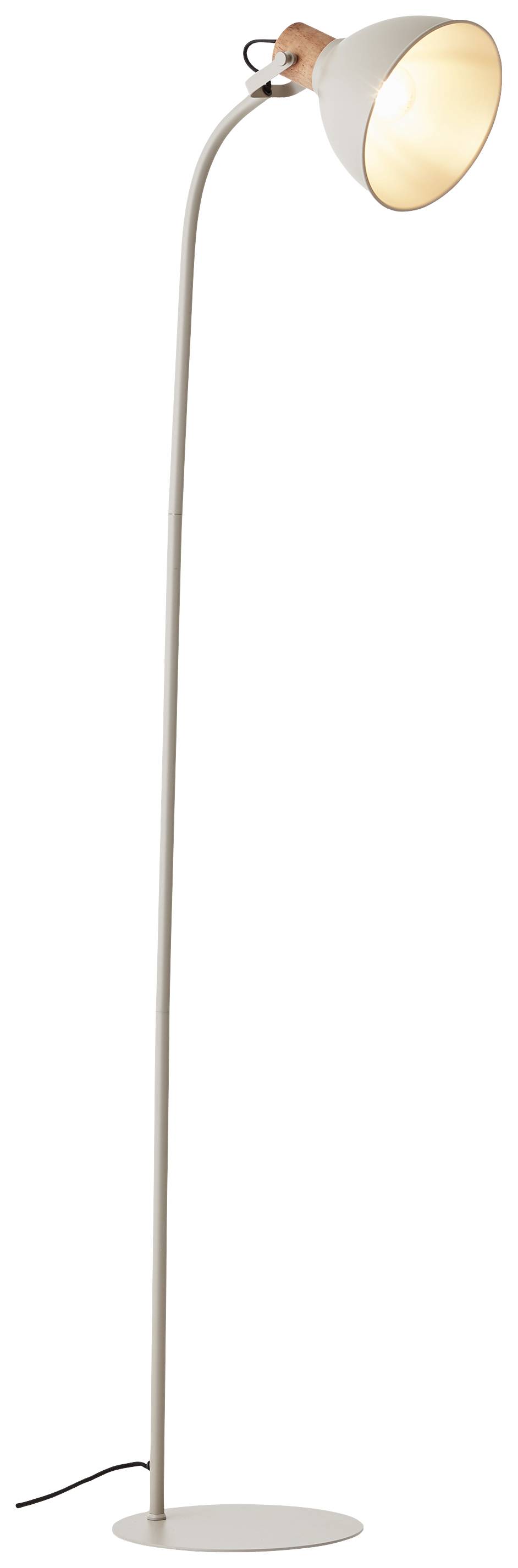 Vysoká obloukovitá stojací lampa s bílým stínidlem stojí vzpřímeně a teplé světlo dopadá dolů.