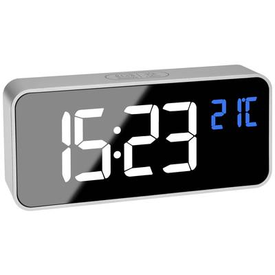 Digitální budík zobrazuje čas '15:23' a teplotu '21°C'. Stříbrný rámeček s černým displejem a modrou teplotní indikací.