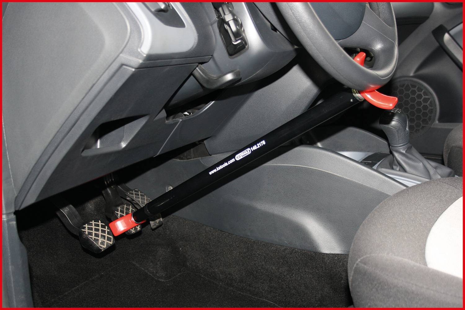Zámek volantu v automobilu, upevněný k pedálům. Chrání před neoprávněným řízením blokováním volantu a pedálů.