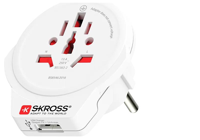 Bílý cestovní adaptér se zásuvkami pro různé země. Zobrazen logo 'SKROSS' a USB port.