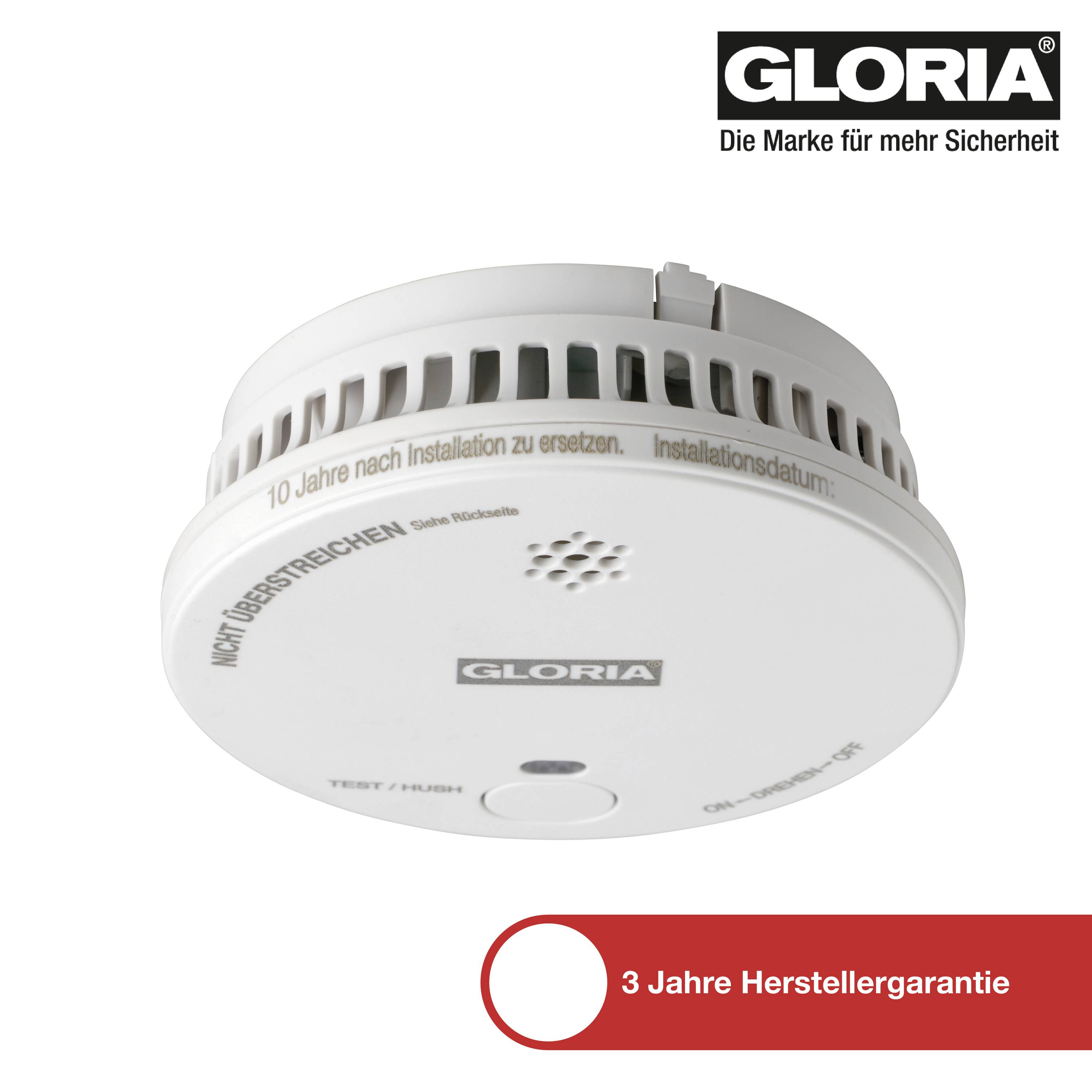 Kulatý detektor kouře s větracími otvory a nápisem 'NEOTEVÍRAT'. Vpravo nahoře logo GLORIA, dole text '3 roky výrobní záruka'.