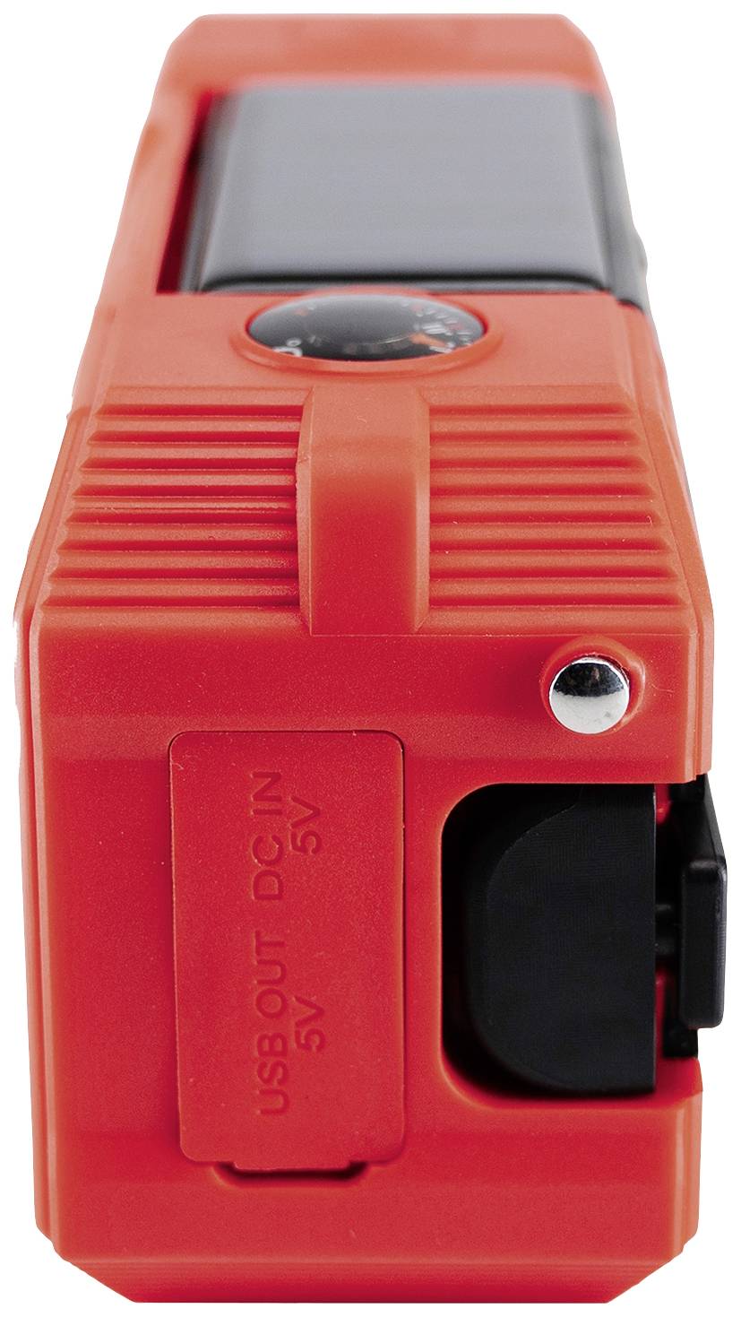 Přenosné oranžové zařízení s USB portem, pravděpodobně nouzové rádio nebo nabíječka, určené pro outdoorové aktivity.