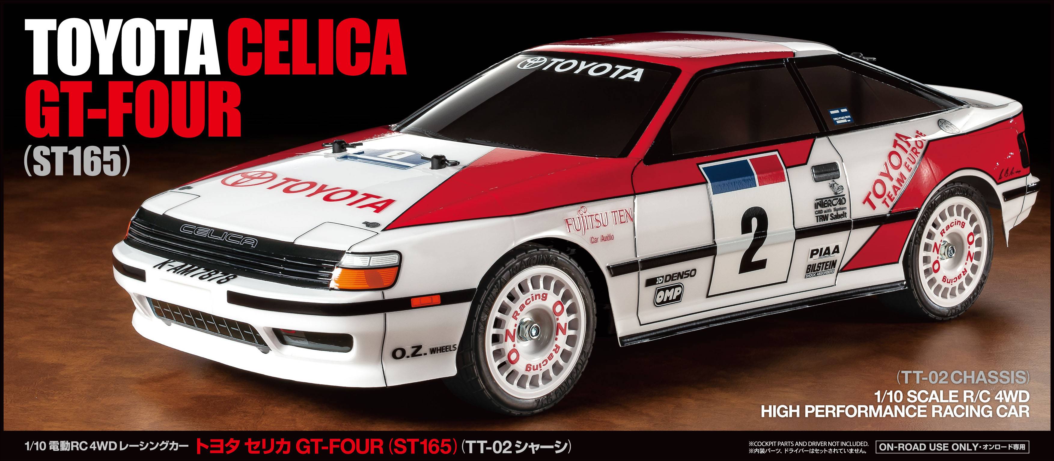 Bílý a červený model vozu Toyota Celica GT-Four (ST165) v rallye designu se startovním číslem 2. Vlevo nápis 'TOYOTA CELICA GT-FOUR (ST165)'.