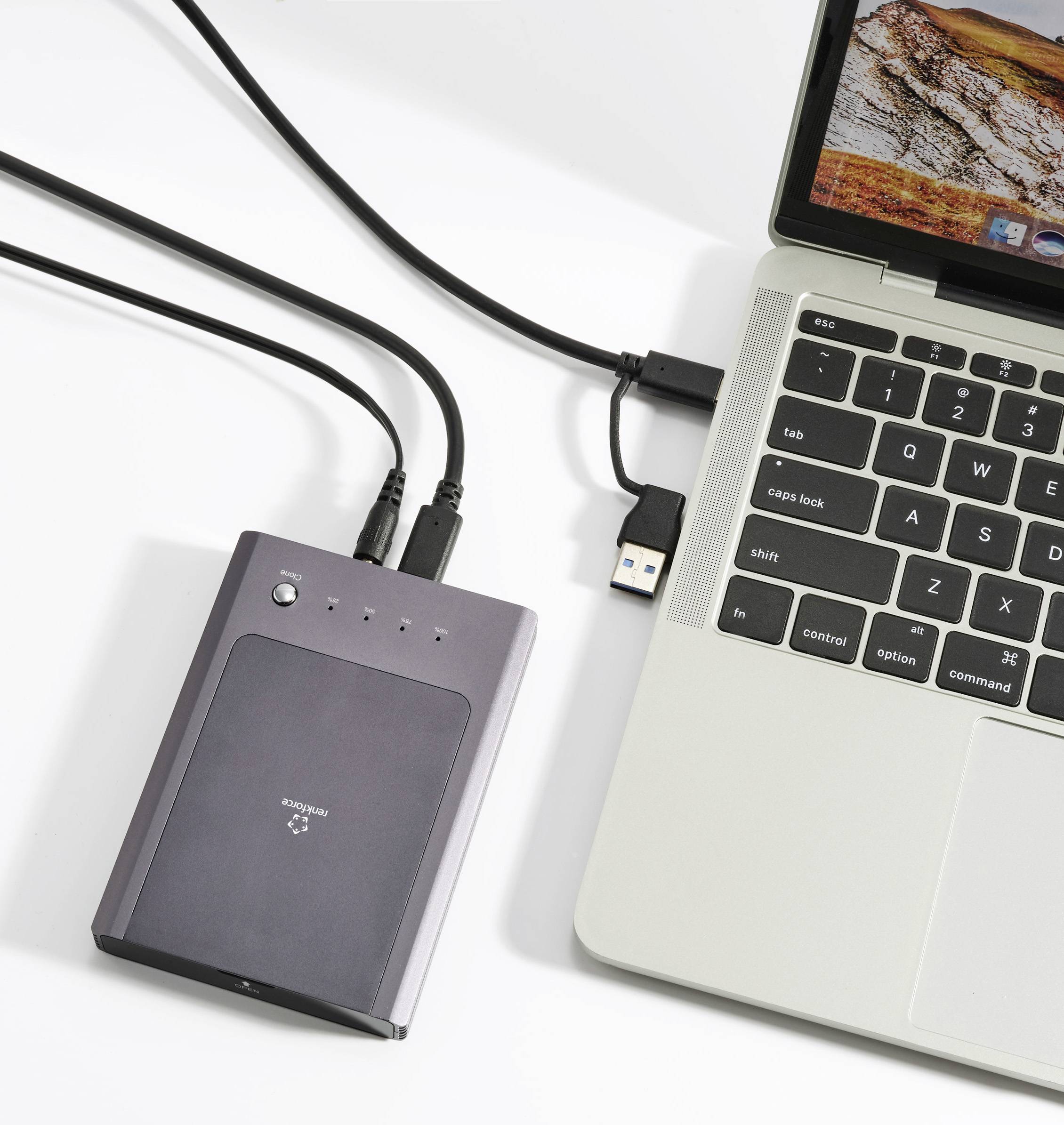 Externí pevný disk a laptop propojené kabelem.