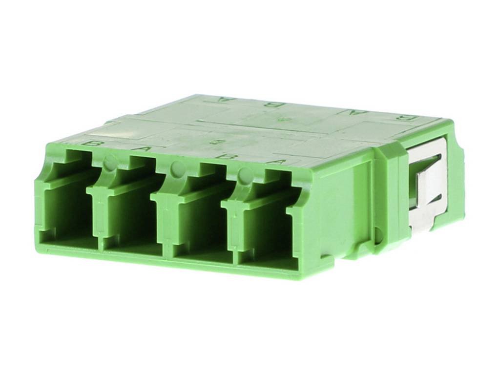 Zelený elektrický konektor se čtyřmi konektorovými místy a kovovým klipem na straně.