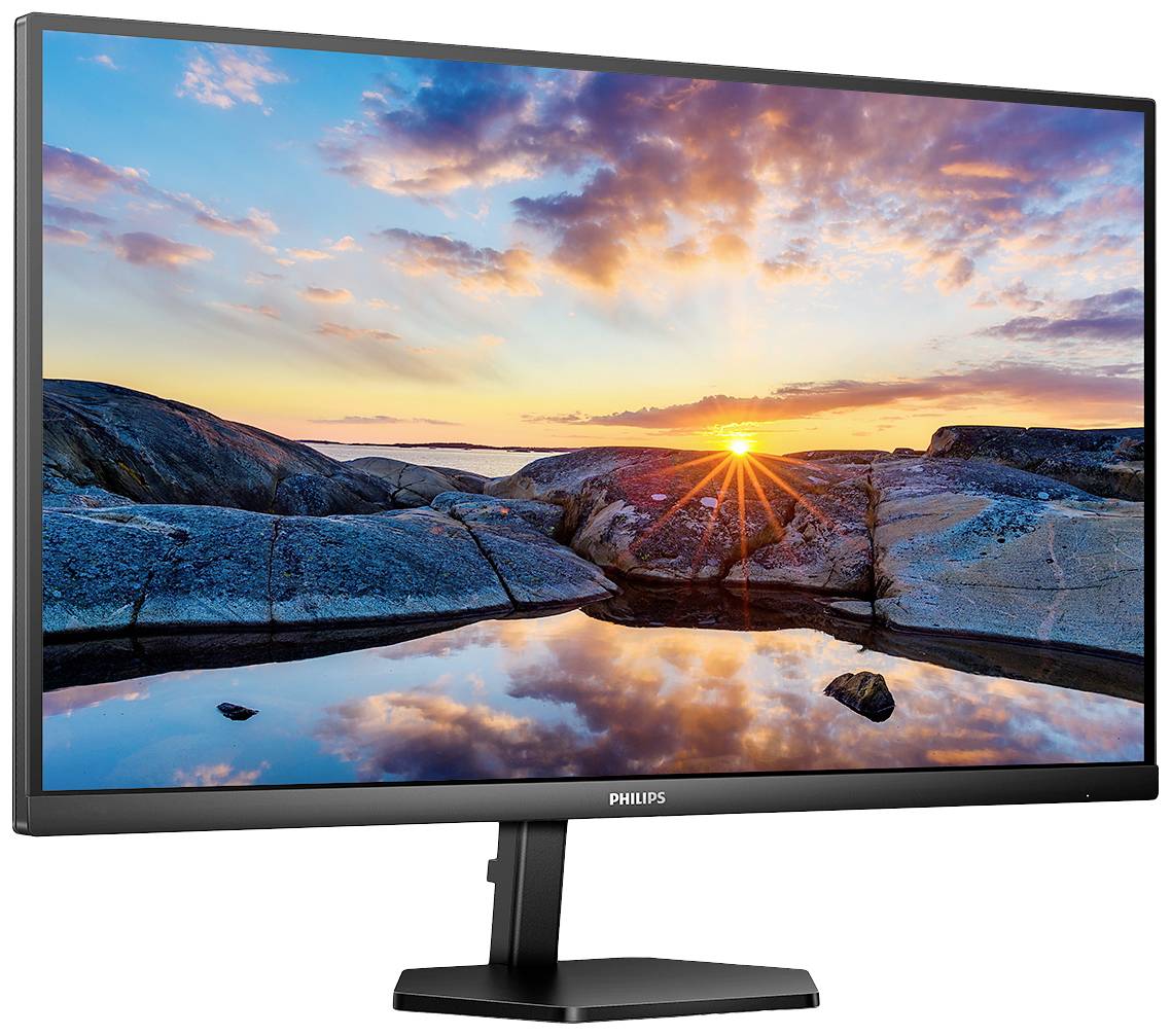 Monitor od Philips zobrazuje krajinný obraz se západem slunce nad skalami u moře, odrážející se v klidné vodní hladině.