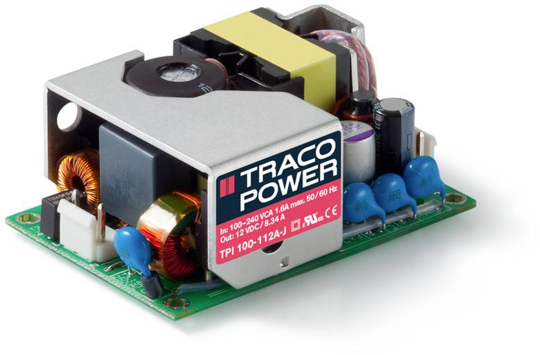 Otevřený elektronický napájecí zdroj s komponenty jako transformátor, kondenzátory a cívky. Označení 'TRACO POWER' na červeném štítku.
