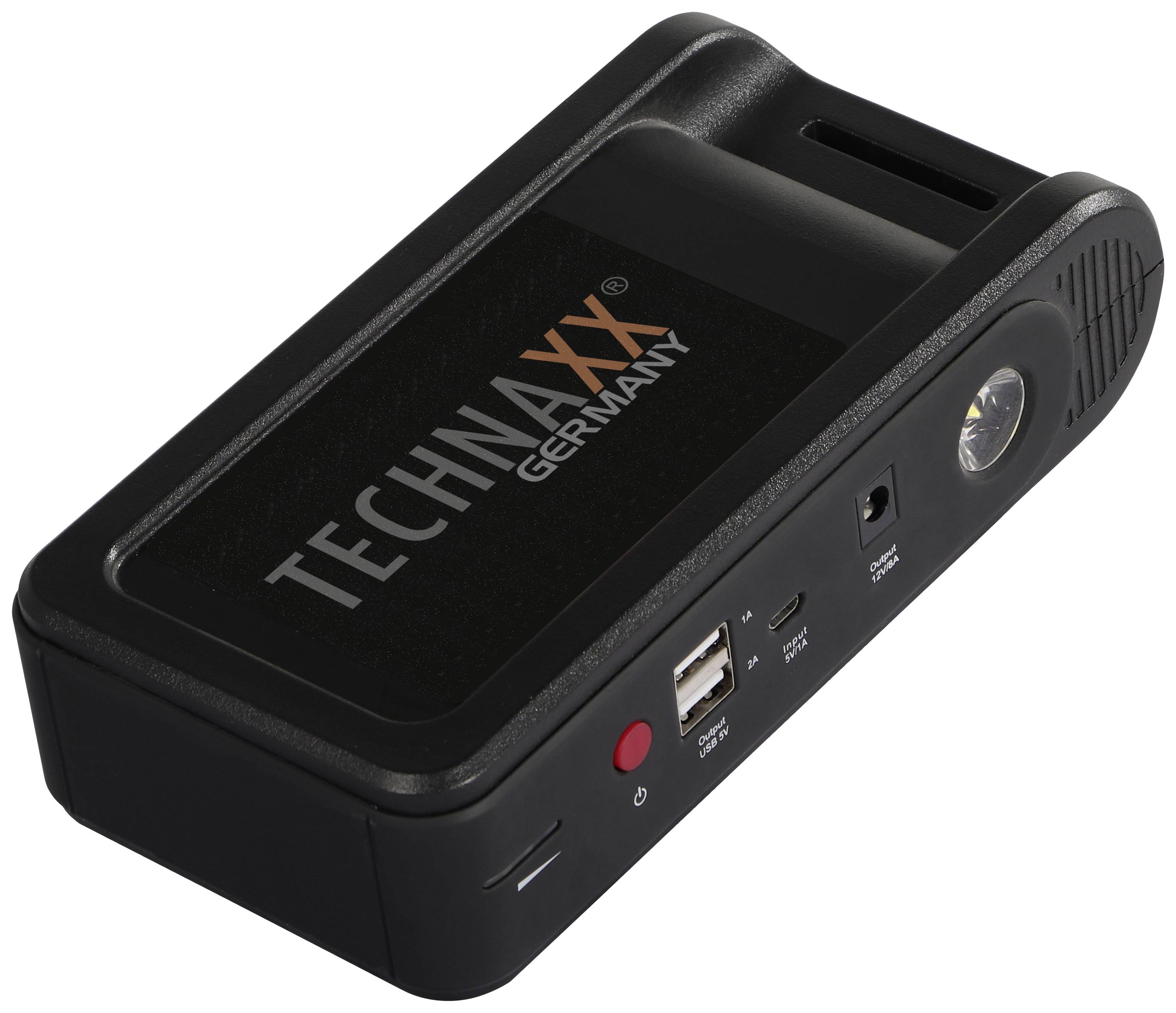 Přenosná černá nabíječka značky Technaxx s USB porty a vestavěnou baterkou, vhodná pro mobilní zařízení.