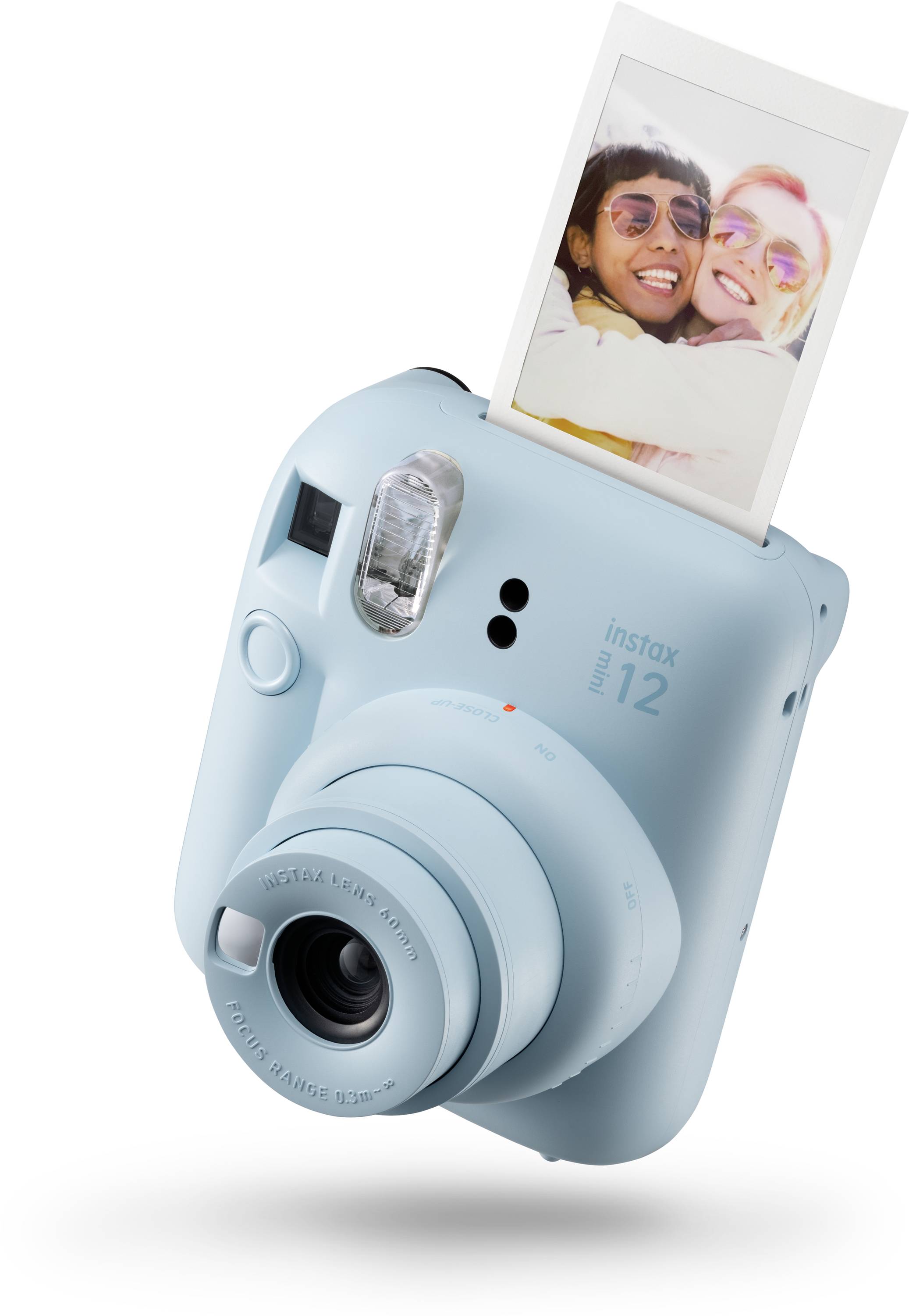 Instantní fotoaparát v pastelově modré barvě tiskne fotografii smějícího se páru.