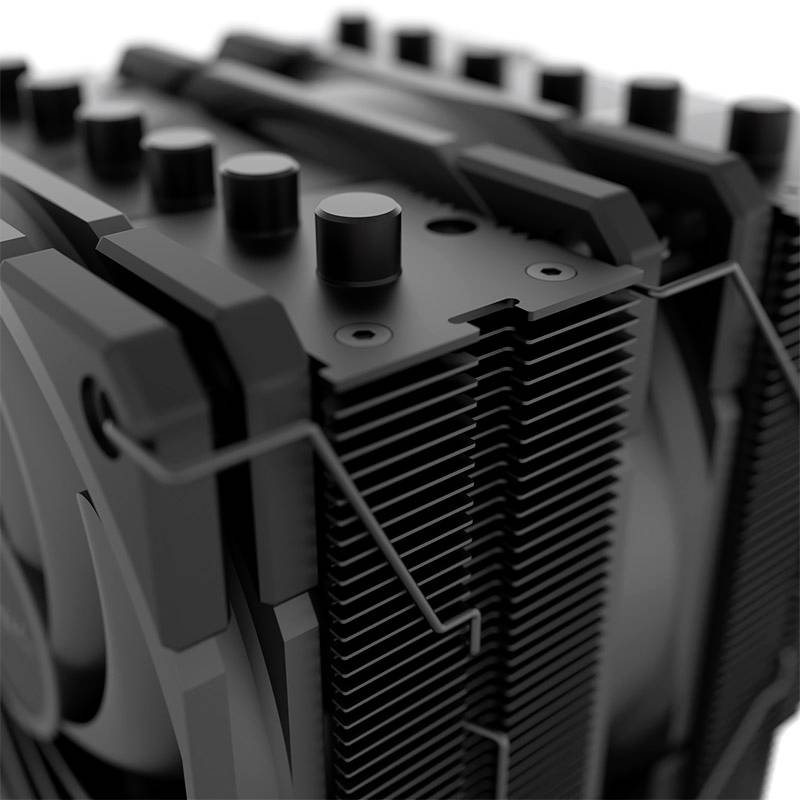 Detailní záběr chladiče s ventilátorem, žebry a šrouby, pravděpodobně určený pro chlazení počítačových komponentů.