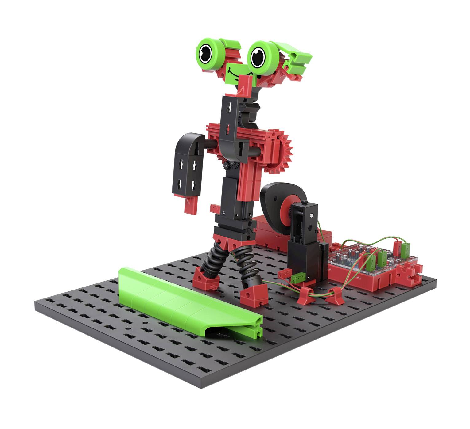 Malý robot složený z červených a černých součástí s zelenými akcenty, stojící na šedém podkladu.