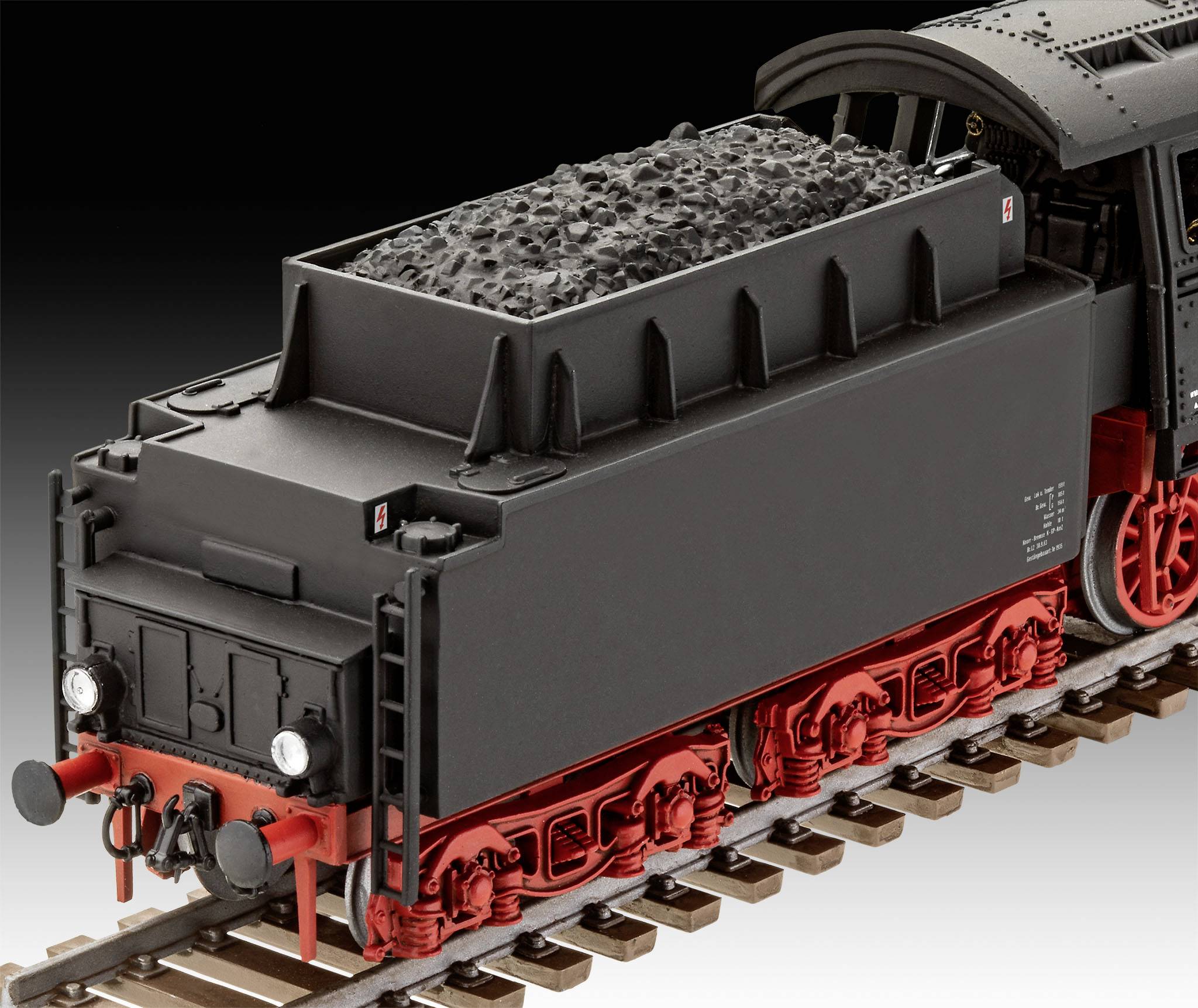 Model historické parní lokomotivy s tendrem na kolejích, naložený uhlím, precizně zpracovaný.