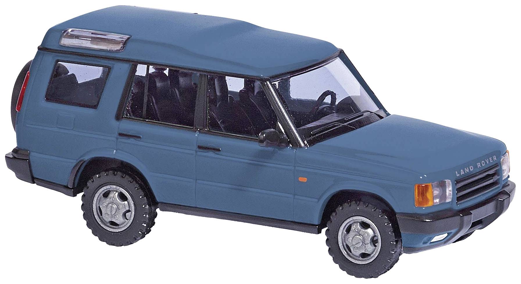 Modré modelové auto terénního vozu z pohledu z boku. Ukazuje detaily jako pneumatiky, okna a charakteristický design karoserie.