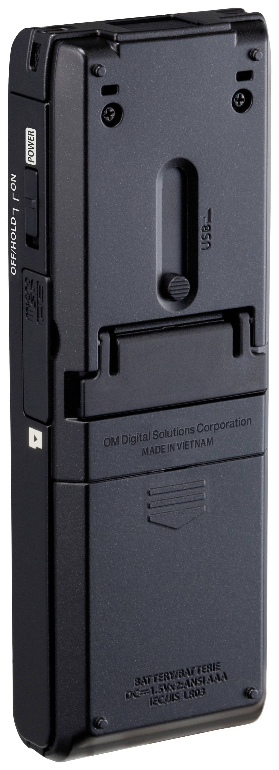 Diktafon v černém pouzdře s USB připojením a prostorem pro baterii. Text: 'OM Digital Solutions Corporation, Vyrobeno ve Vietnamu'.