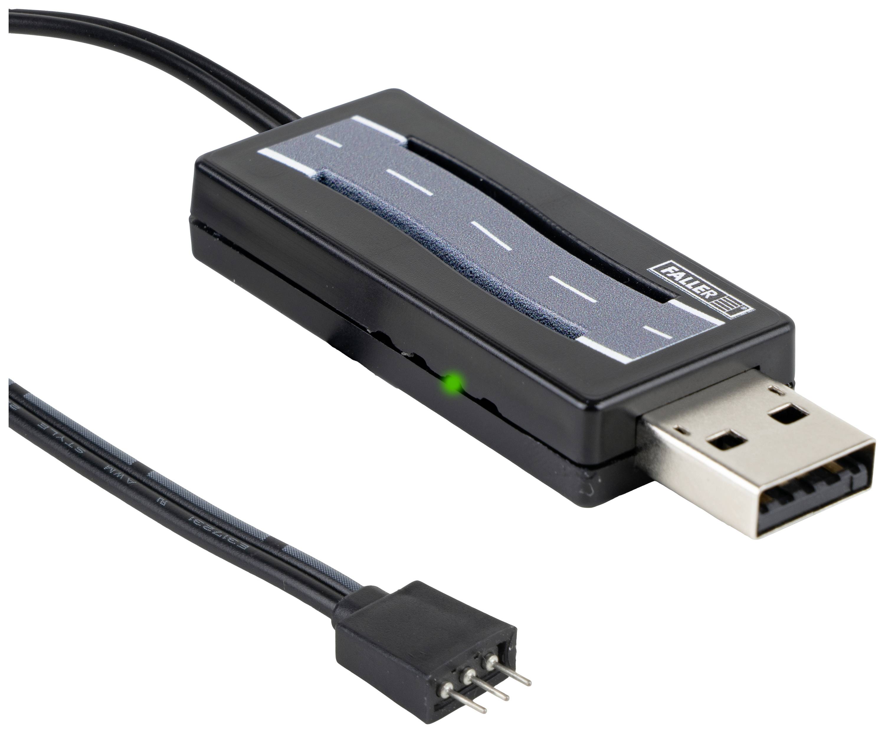 USB zařízení ve tvaru silnice s připojovacím kabelem a zástrčkou. Na zařízení je nápis 'Faller'. Indikátor svítí zeleně.