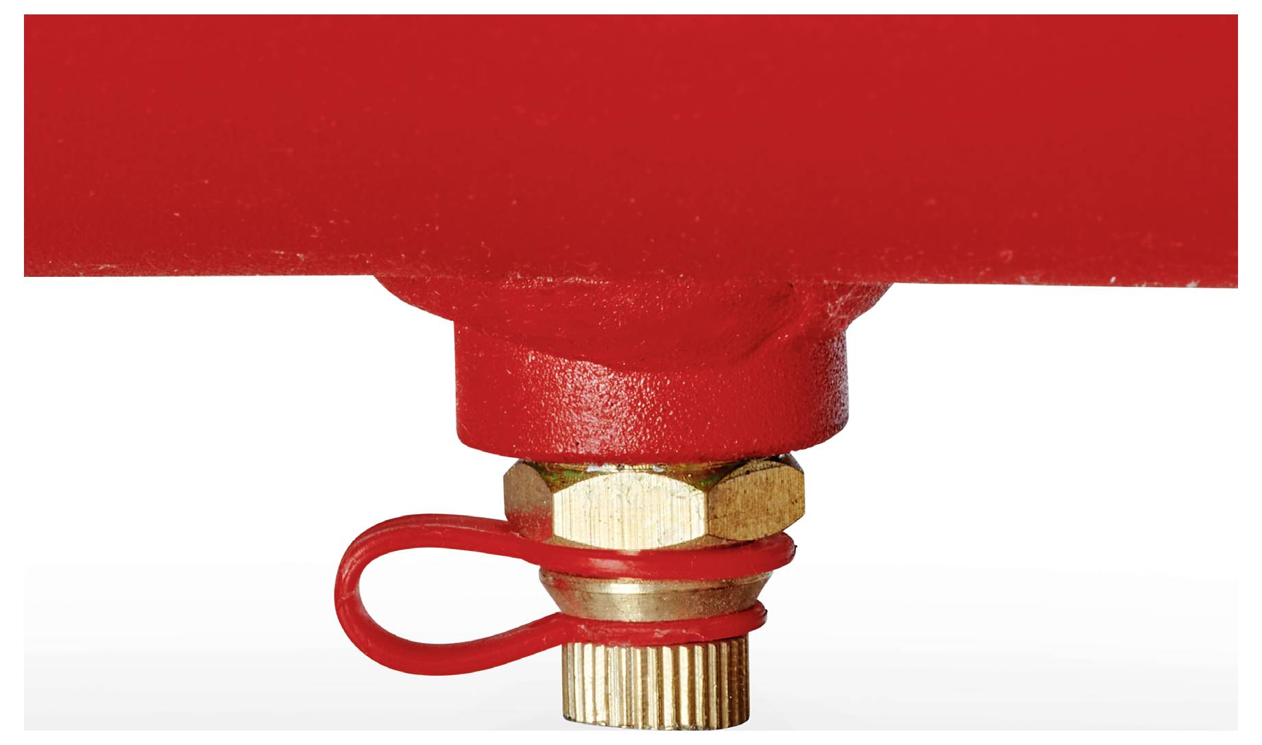 Detailní záběr červené hasičské sprinkleru s mosazným spojením a pojistným kroužkem na bílém pozadí.