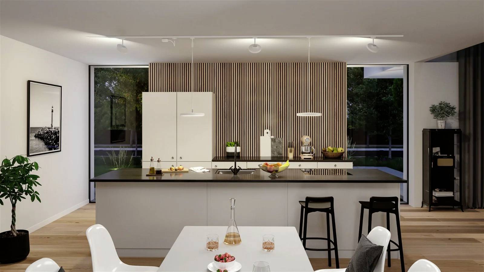 Moderní kuchyně s bílým ostrůvkem. Černé židle, mísa s ovocem a kávovar na pracovní desce. Dřevěné obložení na stěně.