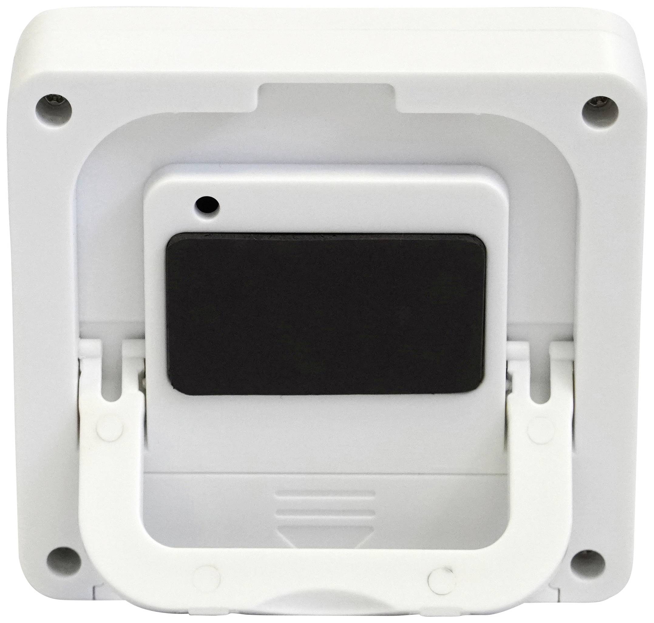 Zadní strana bílého obdélníkového zařízení s kloubovým mechanismem a černou oblastí uprostřed. Zařízení je namontované na stěně.