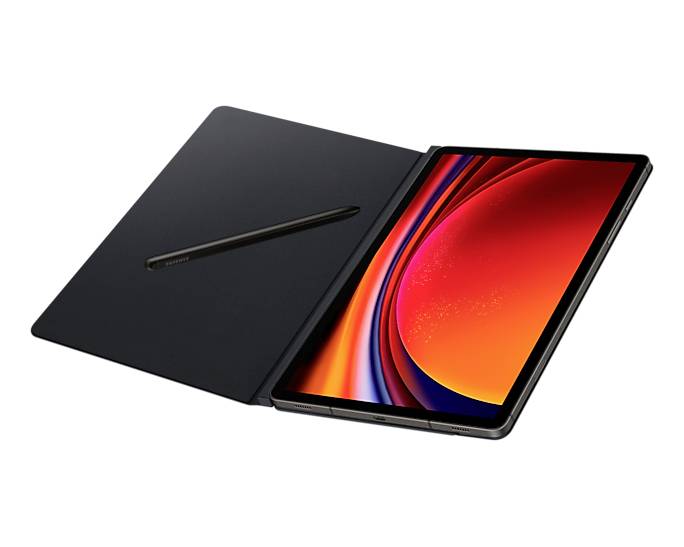 Tablet s osvětleným displejem a stylusem, otevřený na černém podkladu.