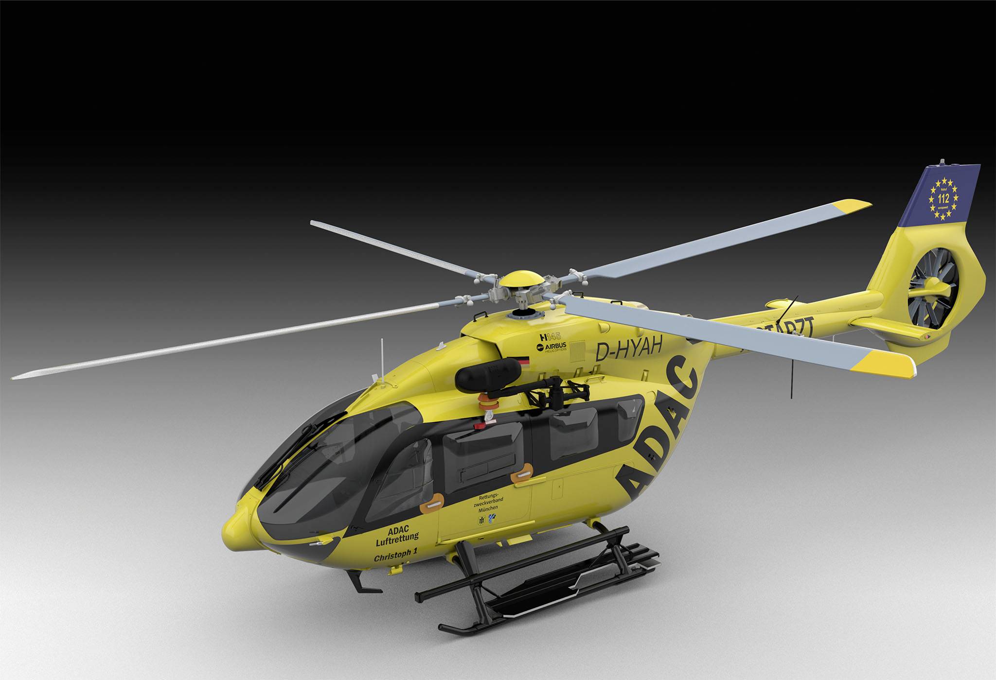 Žlutá záchranná helikoptéra ADAC s nápisem. Vozidlo má dvě rotorová křídla a je vybaveno pro zásahy při mimořádných událostech.