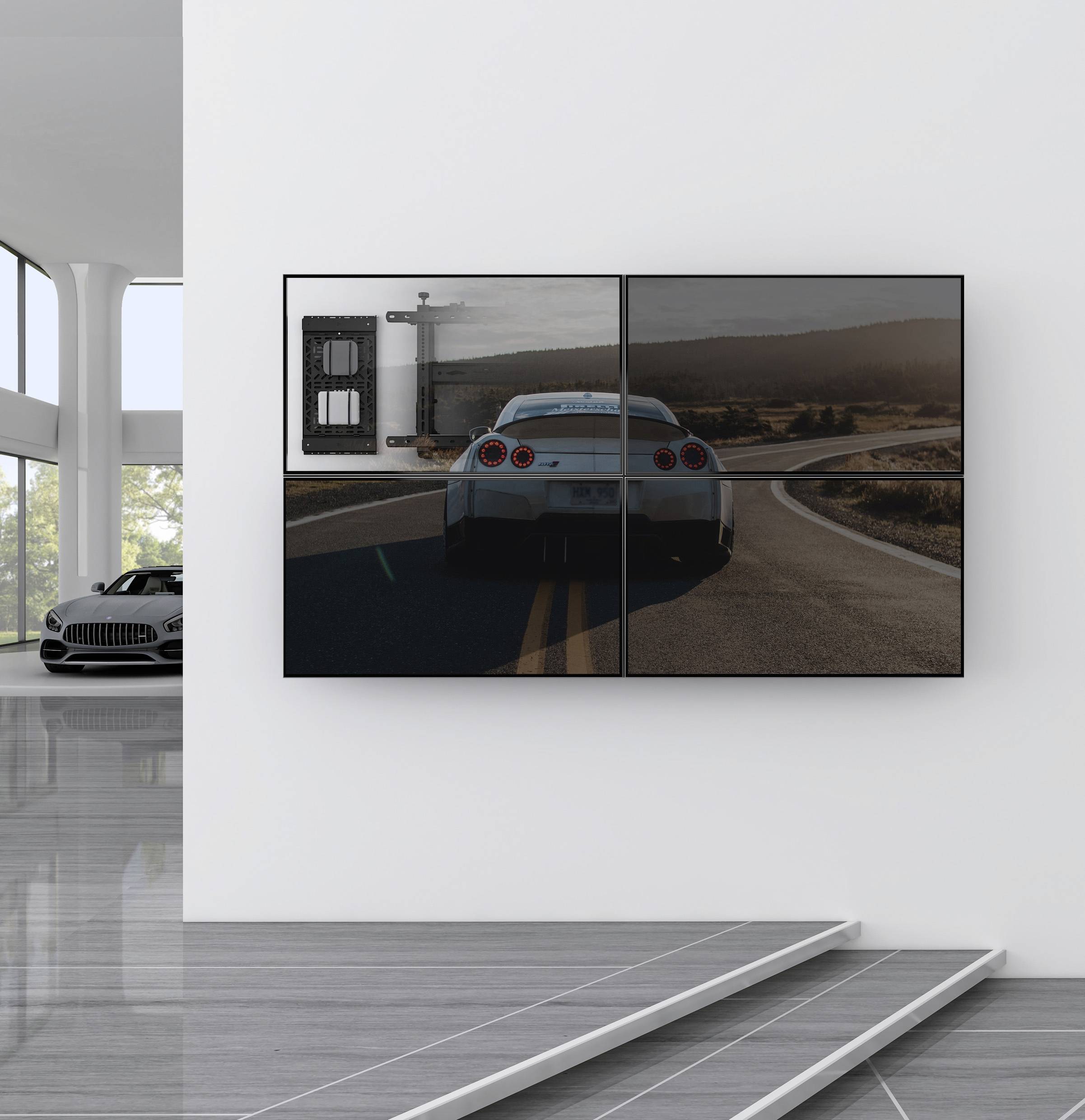 Nástěnná umělecká instalace: Rozdělený obraz zobrazuje automobil na klikaté silnici. V pozadí jsou viditelné kopce.