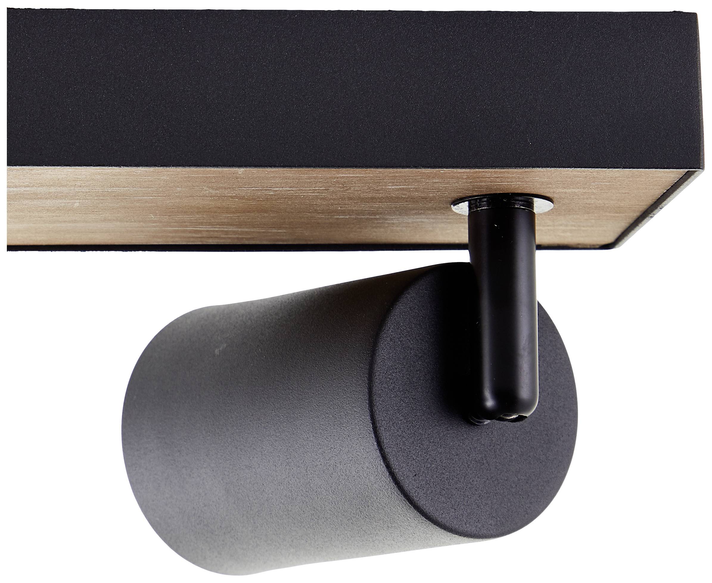 Černý válcový reflektor na stropě, zdůrazňující moderní design a minimalistickou estetiku.