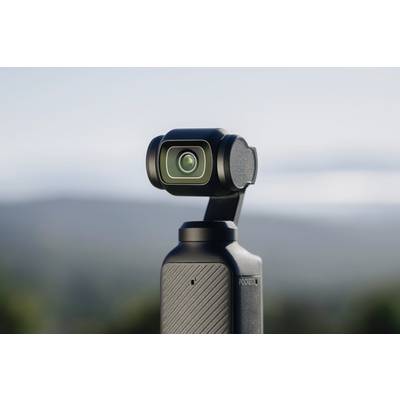 Černý kompaktní fotoaparát s gimbálem na rozmazaném pozadí; vhodný pro cestování a vlogování.