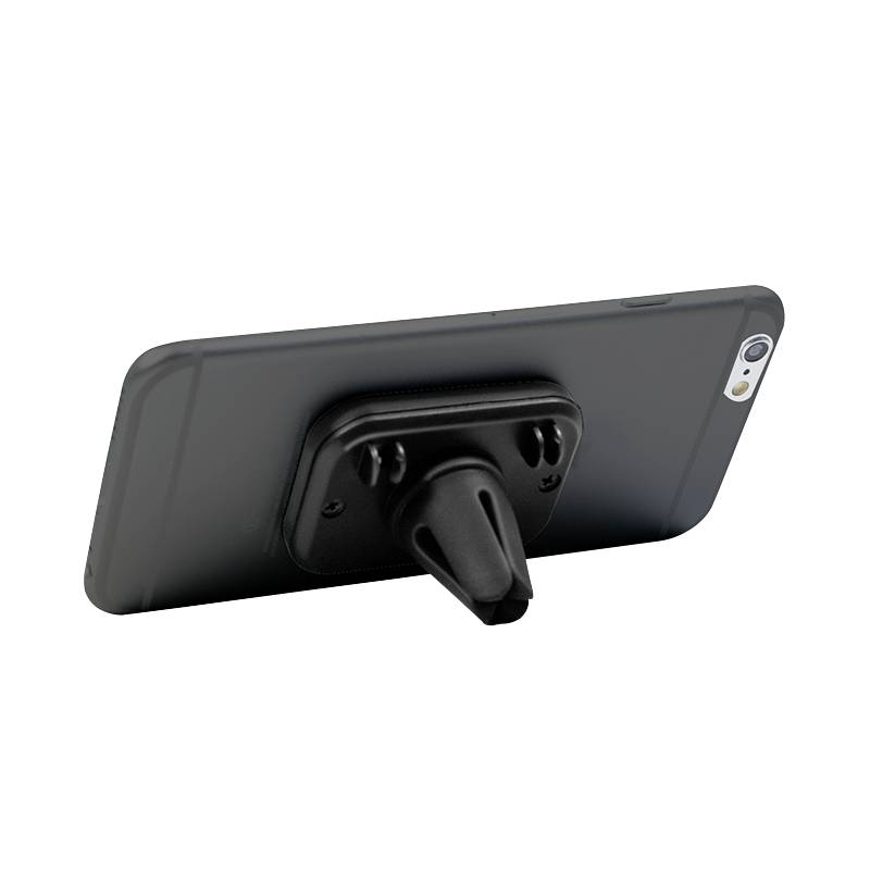 Černý držák na smartphone připevněný k mobilnímu telefonu, který leží stranou na stole.