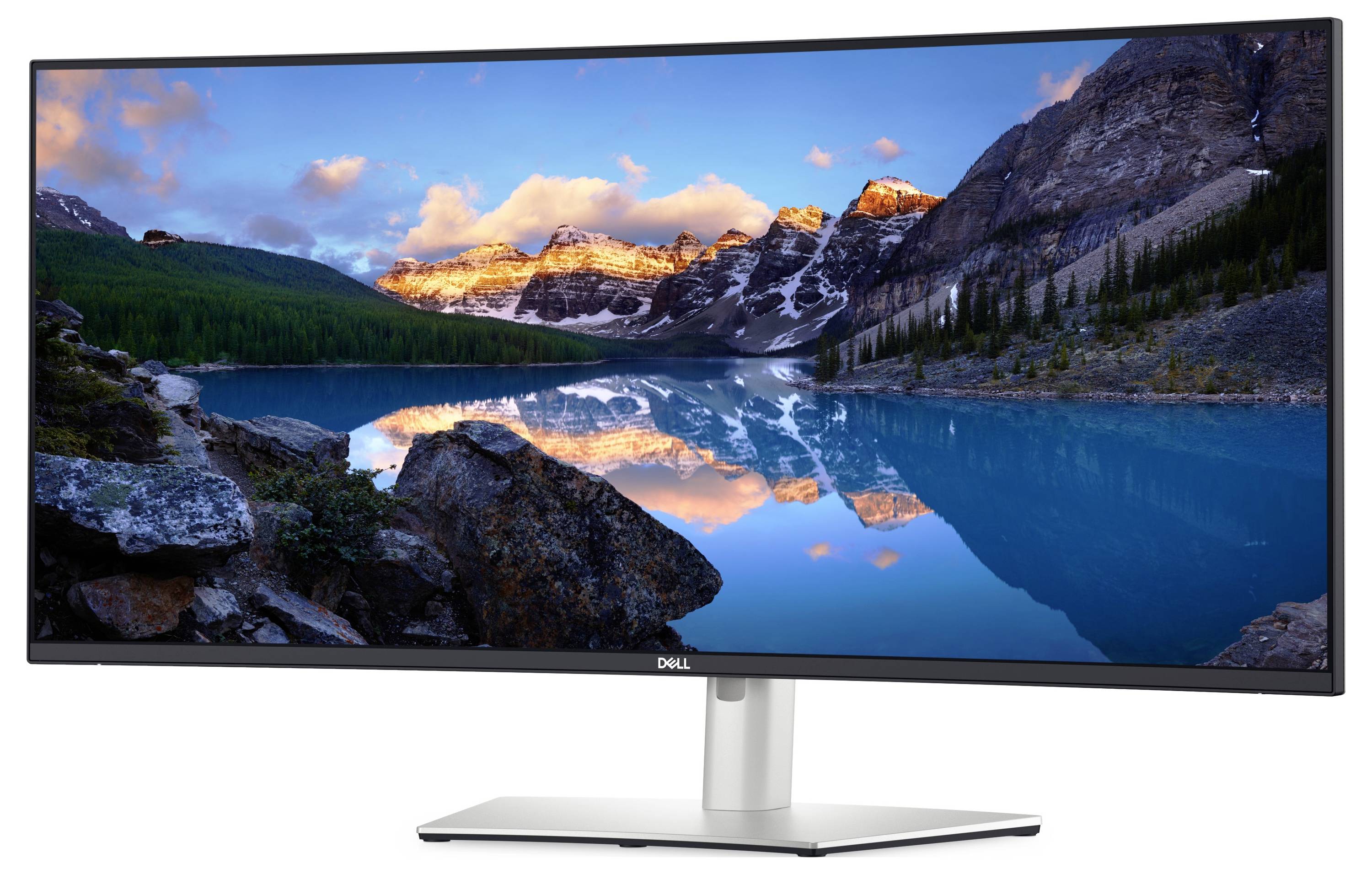 Monitor Dell zobrazující živou krajinu s horami, jasnou oblohou a klidným jezerem odrážejícím scenérii.