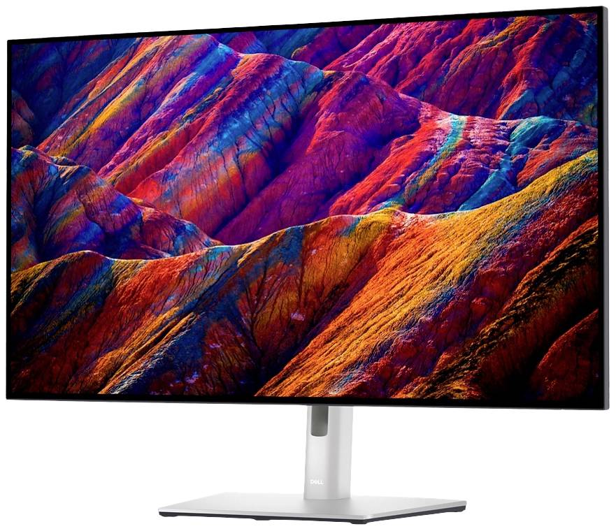 Počítačový monitor zobrazuje živě zbarvené horské panorama. Barvy sahají od červené přes fialovou až po modrou a vytvářejí dynamický obraz.