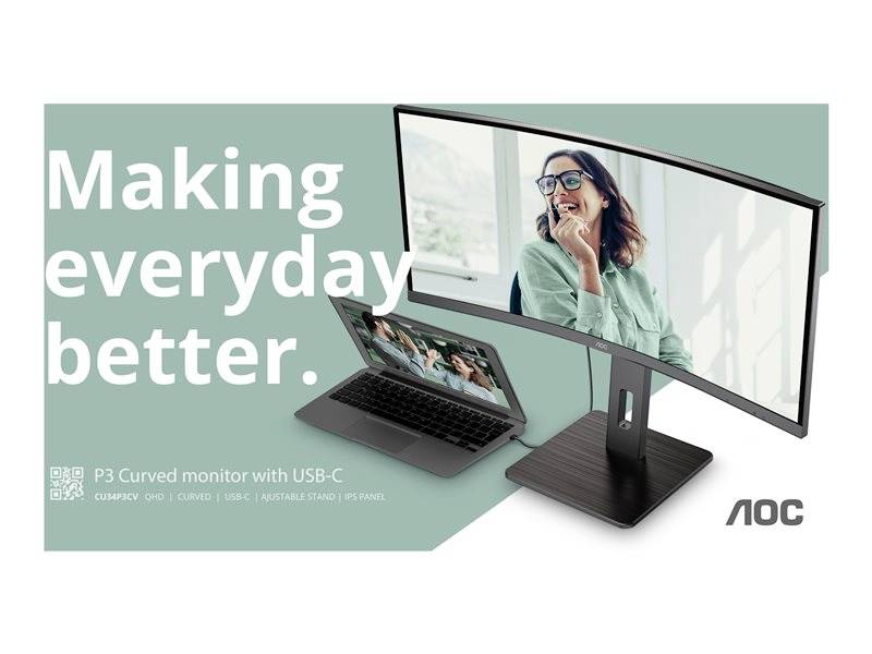 Prohnutý monitor zobrazuje usmívající se ženu. Vedle něj je notebook, oba s nápisem 'Making everyday better.' a logem AOC.