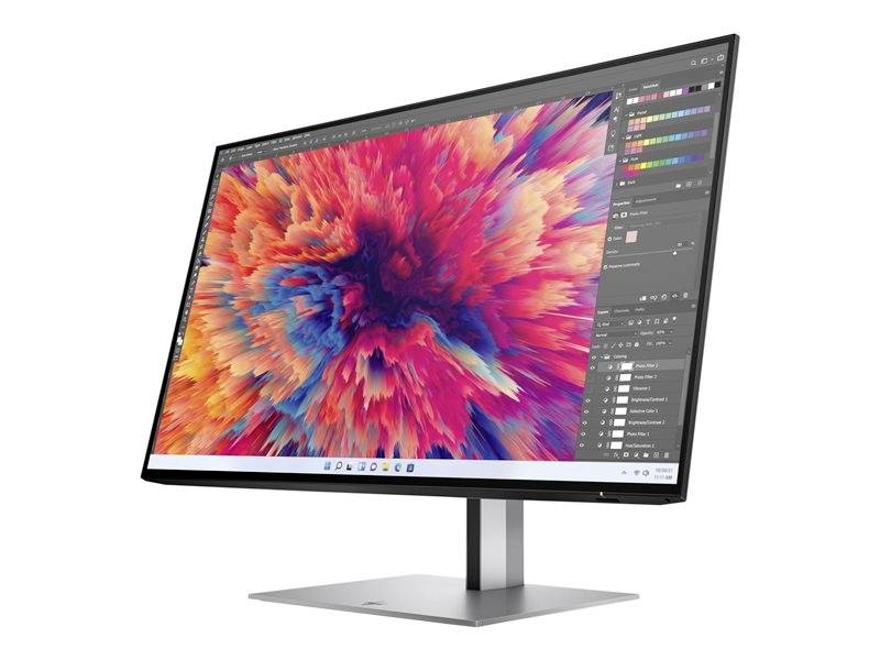 Počítačový monitor zobrazuje digitální umělecké dílo s barevnými, abstraktními tvary. Software pro úpravu je otevřený.
