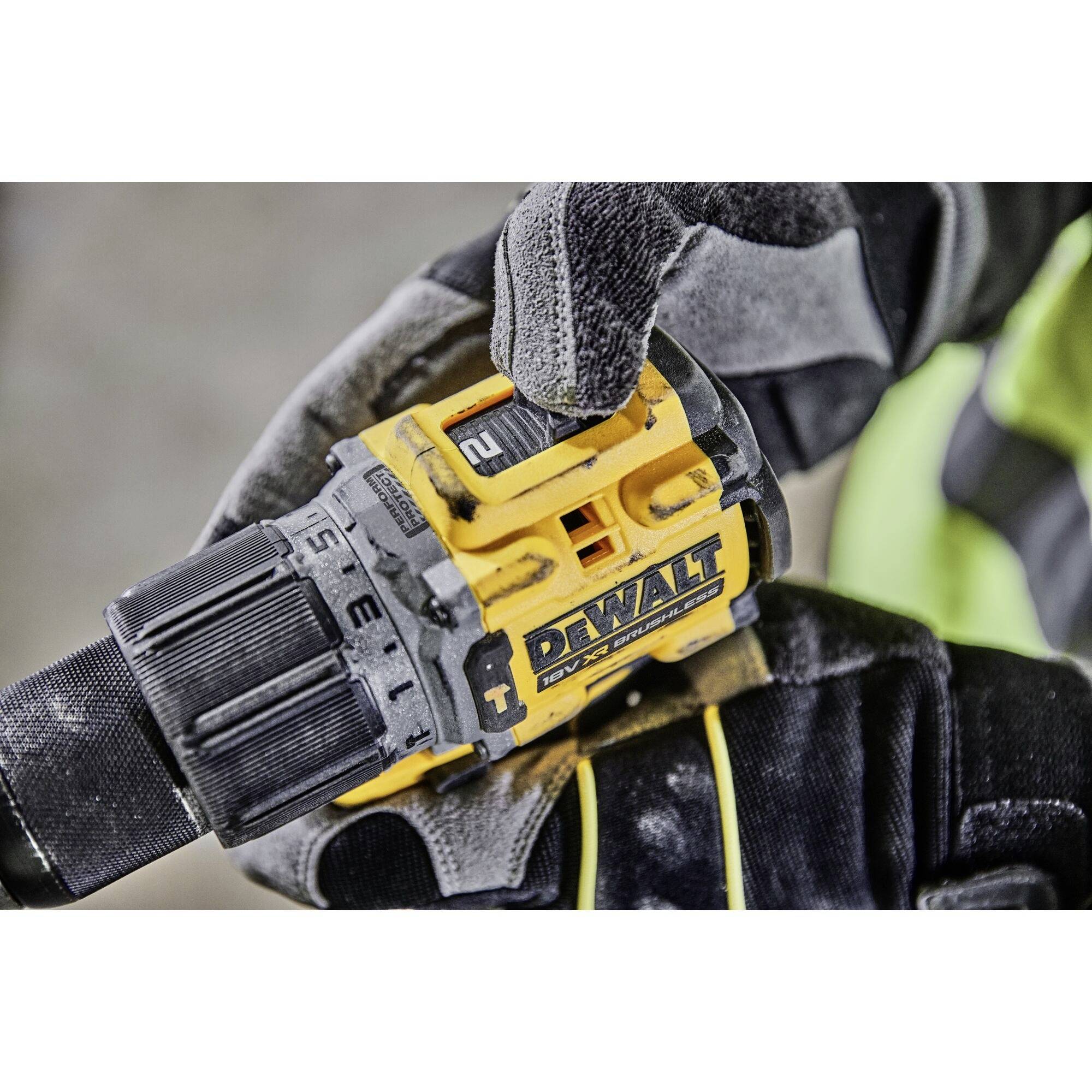 Ruka drží vrtačku DeWalt, zaměření na nastavení momentu a firemní logo.