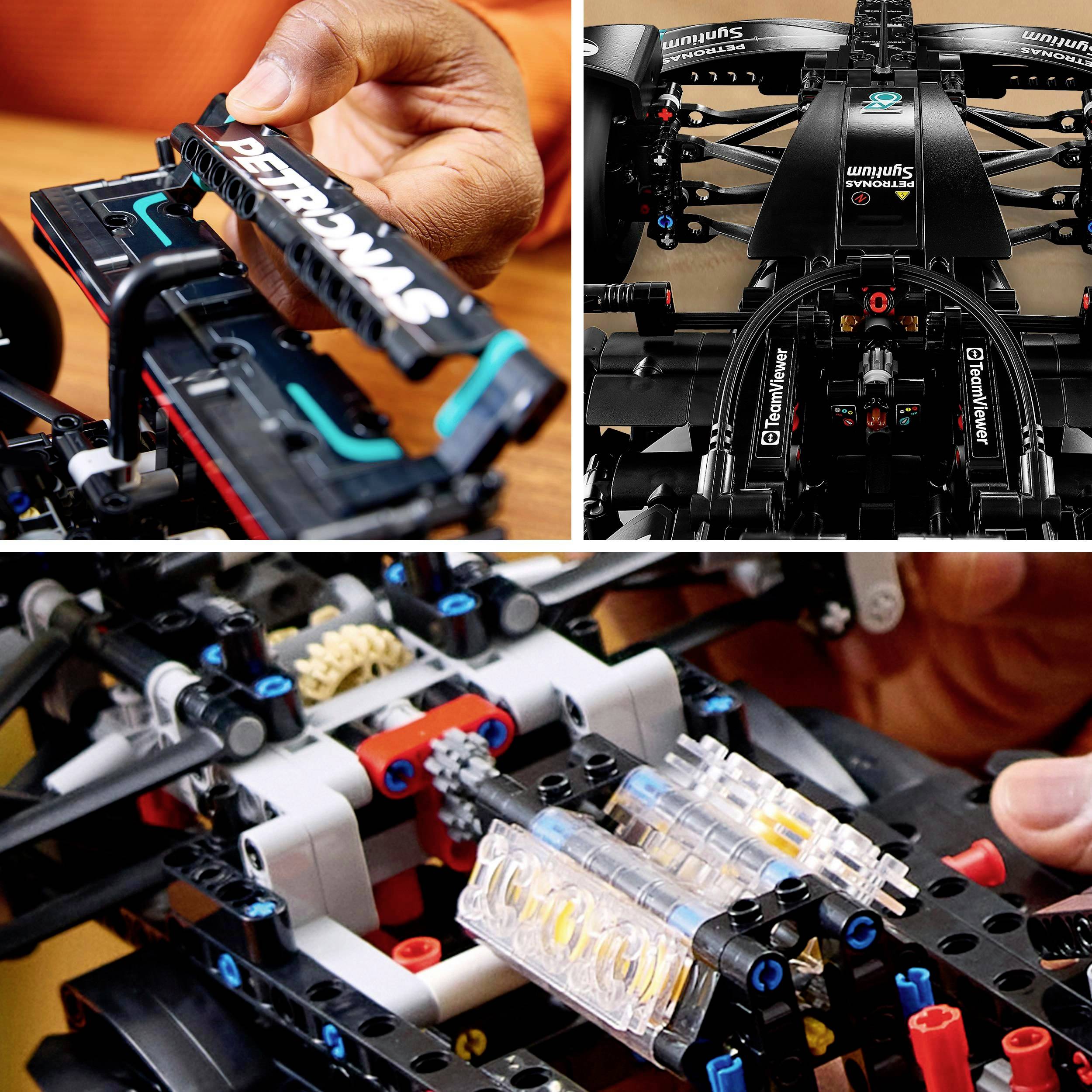 Osoba montuje detailní LEGO model formule 1 s logem PETRONAS. Obrázek ukazuje ruční práci a detaily vozidla.