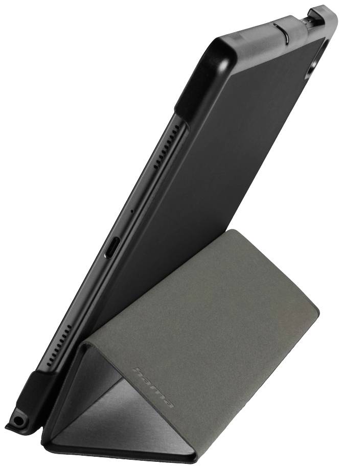 Tablet leží šikmo na tmavě šedém, trojúhelníkově složeném obalu, který slouží jako stativ.