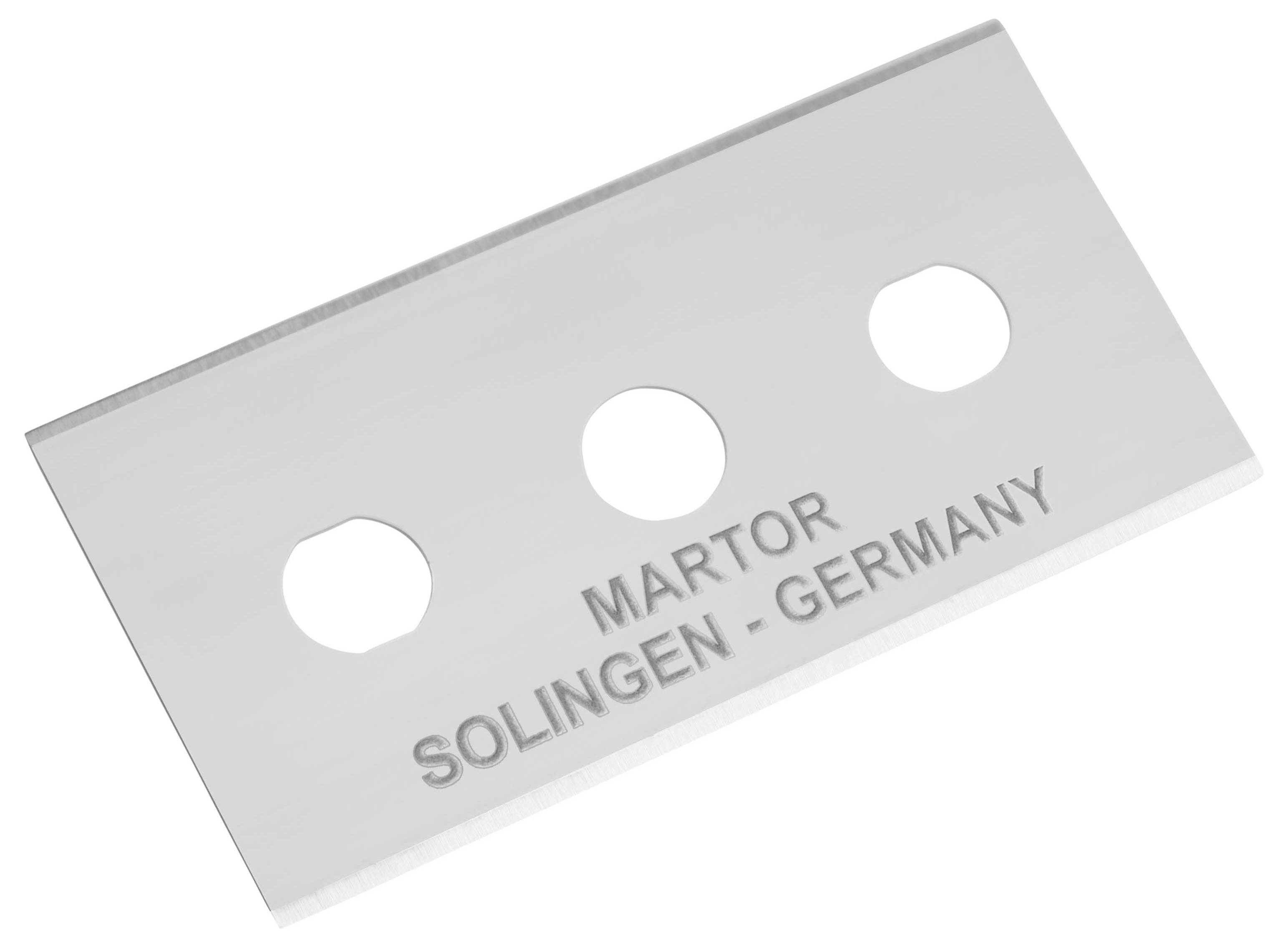 Trapézový nůž se třemi kulatými otvory a nápisem 'Martor Solingen - Germany'.