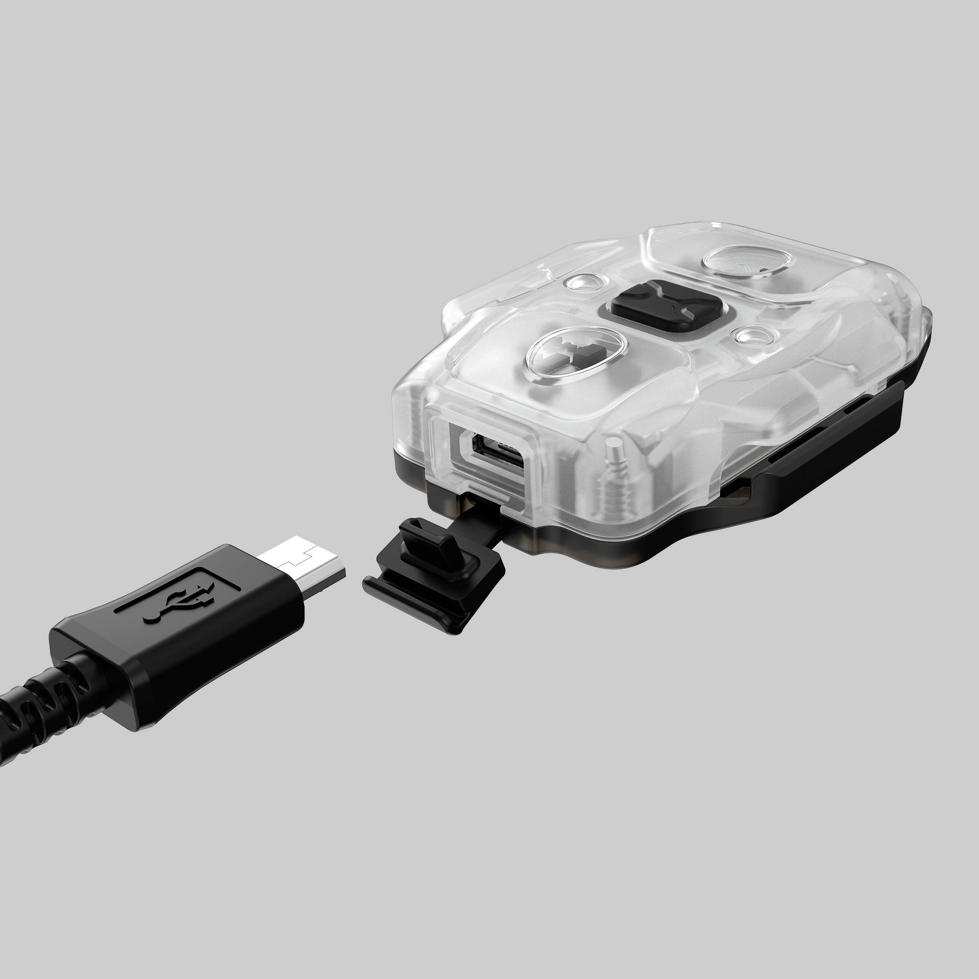 Průhledné elektronické zařízení s USB portem, které má malé pouzdro a končí odděleným kabelem.