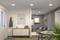 Moderní obytný prostor s šedými stěnami, sedací soupravou, stolem se židlemi a komodou. Rostliny a nástěnné dekorace doplňují interiér.