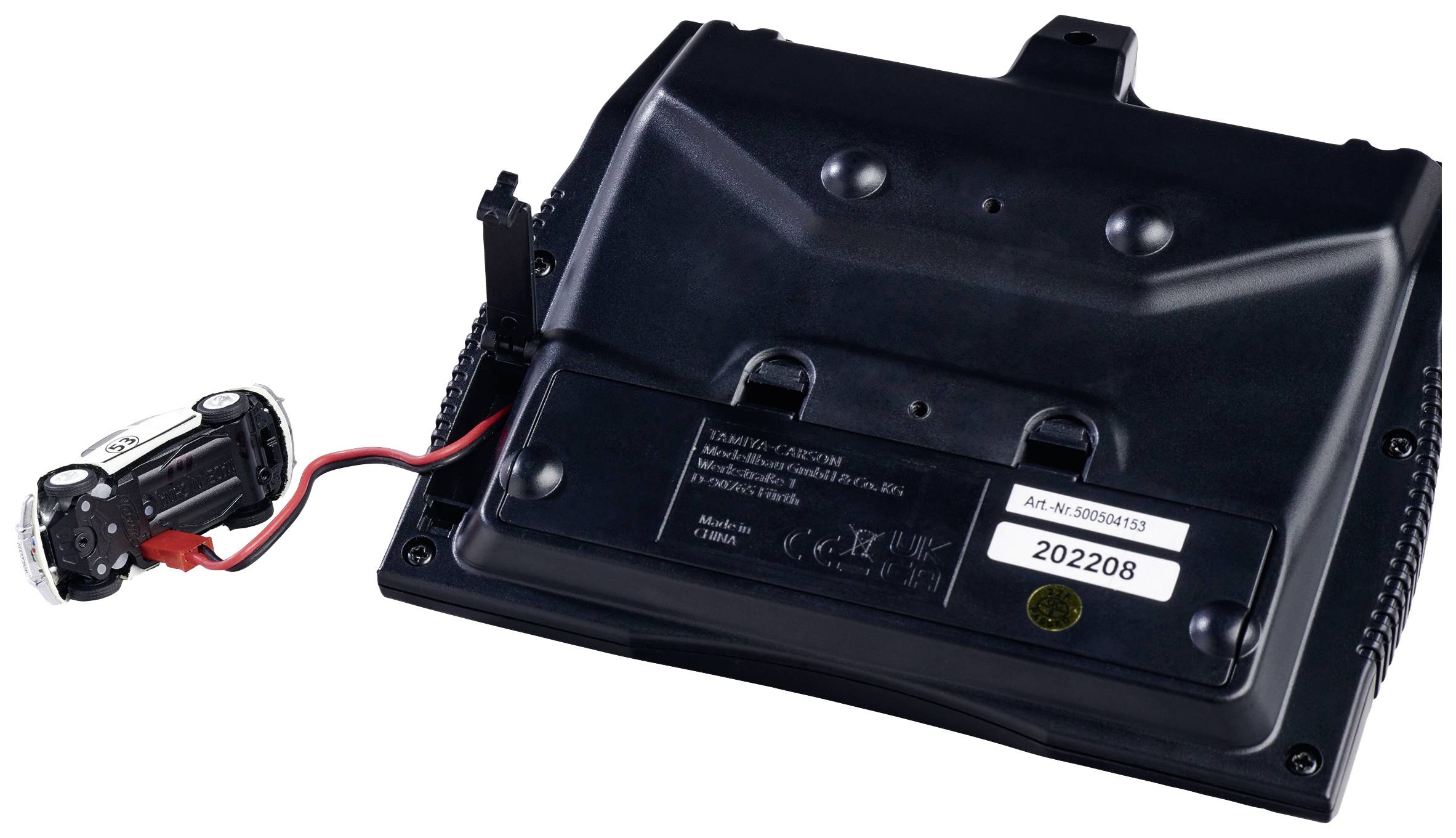 Černý kryt elektronického zařízení se dvěma konektory a připojeným bateriovým prostorem s červeným a černým kabelem.