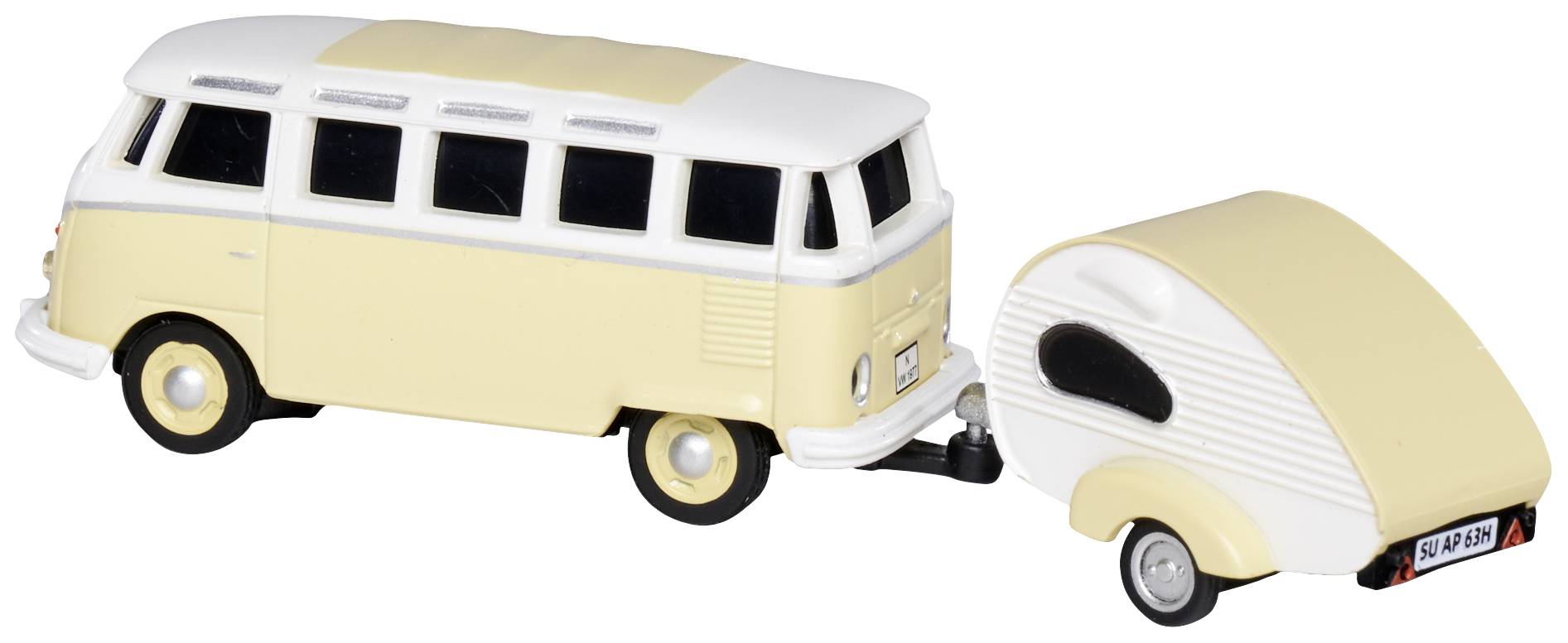 Žlutý model hračkářského VW autobusu s malým obytným přívěsem. Autobus má bílé detaily a okna.