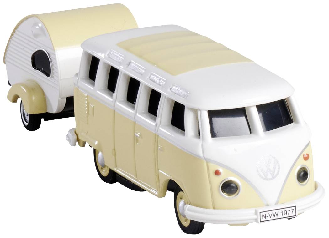 Model hračky klasického VW autobusu s malým obytným přívěsem. Autobus je v krémové barvě s bílou střechou.