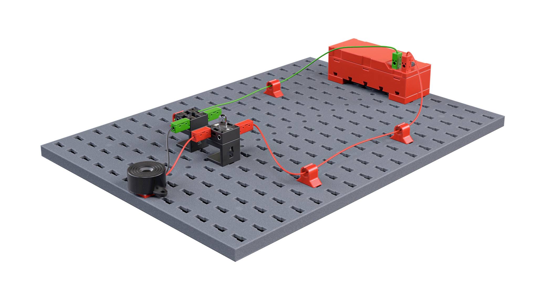 Elektrický obvod z LEGO dílků: baterie, spínač, kabely a motor propojené na šedé desce, zobrazující tok elektrického proudu.