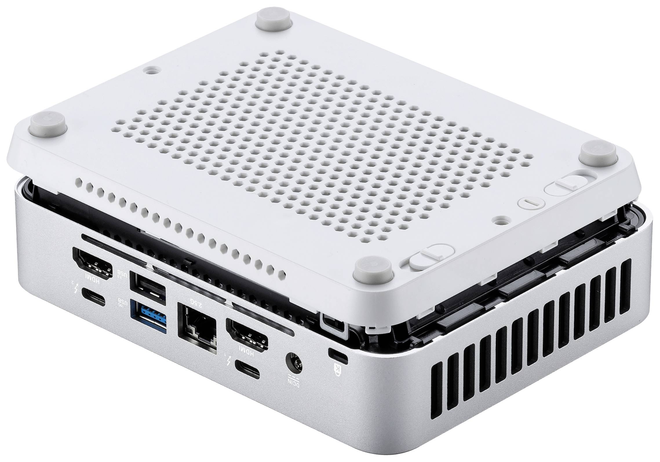Malý otevřený počítač s několika konektory na straně, včetně USB a HDMI, umístěný na bílém pozadí.
